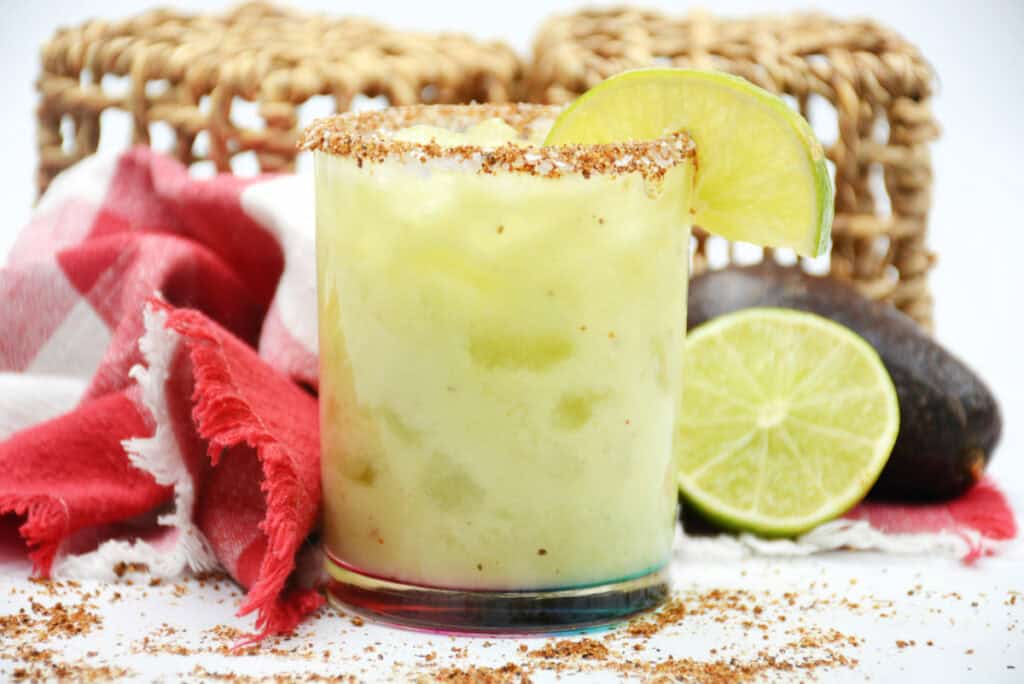 disney cocktail on a table next to an avocado and lime