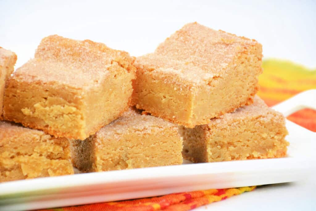 close up of golden brown churro bars on a tray