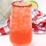 blood orange margarita drink with a lime wedge